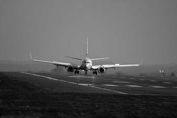 Black and white photo of a G-DRTW just landed in front of heavy rain at EMA - stock photo