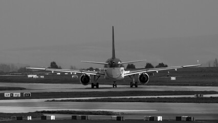 Black and white photo of G- EILA taxiing at Manchester airport - stock photo