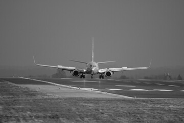 Black and white photo of G-DRTW in the sunshine just in front of heavy rain - stock photo