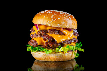 Big cheeseburger four patty tower burger brioche bun grill sandwich beef with melted cheese onion lettuce and gherkins isolated black background reflection