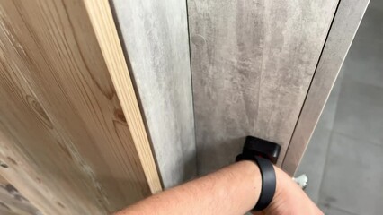 A magnetic key bracelet on a person's wrist touches the electronic door lock and opens the door. A convenient magnetic key bracelet for wearing in the gym. Opening the locker in the locker room 