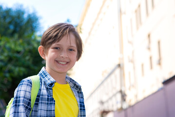 portrait of a happy little boy with a backpack. smiling schoolboy goes to school.	