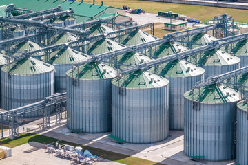 aerial view on rows of agro silos granary elevator with seeds cleaning line on agro-processing...