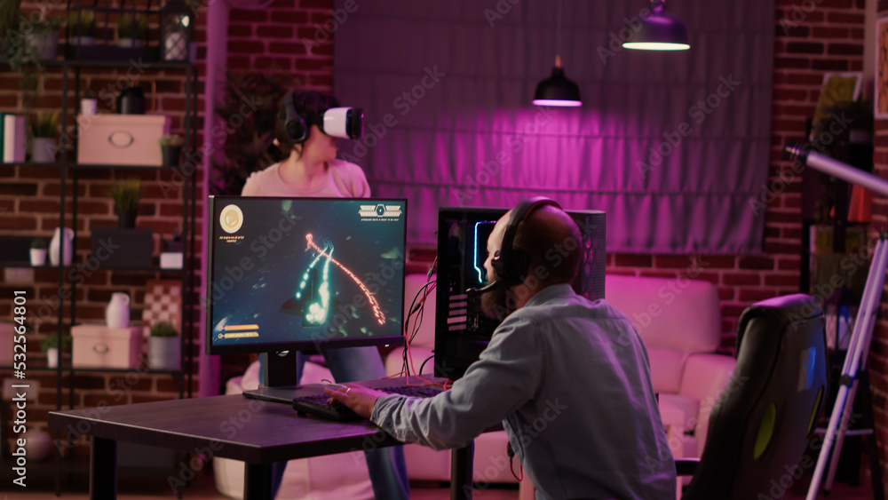 Aufkleber gamer playing multiplayer space shooter while gaming girl is fighting in virtual reality game at hom