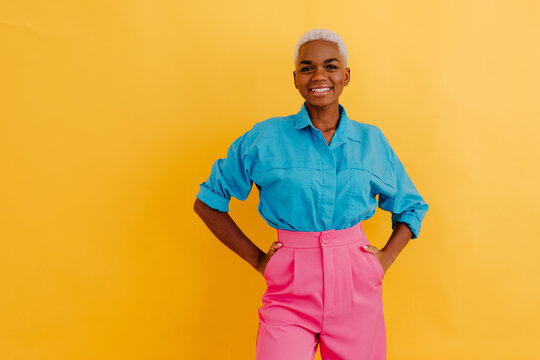 Delighted black woman in trendy outfit
