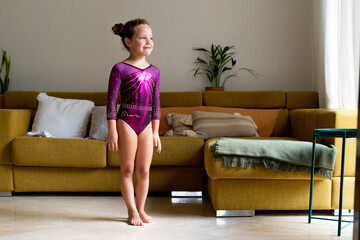 little girl practicing artistic gymnastics at home