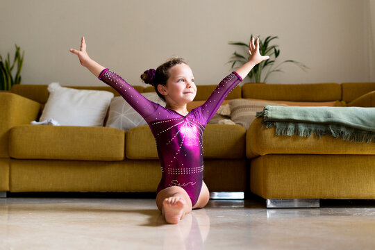 little girl practicing artistic gymnastics at home