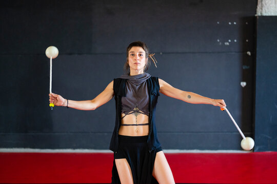 Active woman dancing with poi balls
