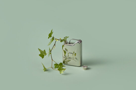 Steel canister with green plant.
