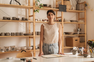 Portrait Of A Female Entrepreneur In The Ceramics Shop