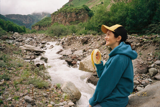 a film shot with a traveler who has a banana in the mountains
