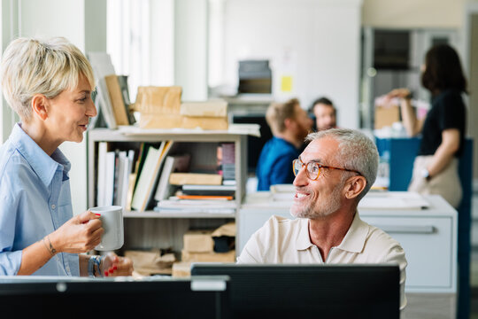Man and Woman Talking in Office