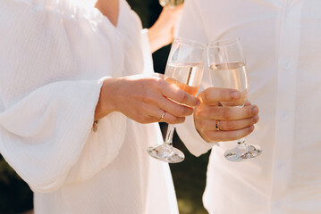 bride and groom holding champagne glasses