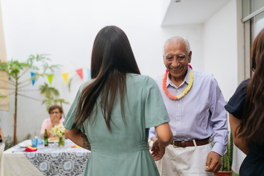 Grandfather and grandaugther dancing together