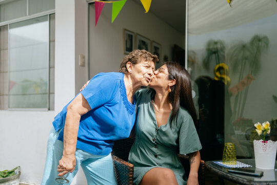 Adult grandaugther kissing grandmother