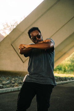 A Dancer Poses Beneath A Bridge In The City
