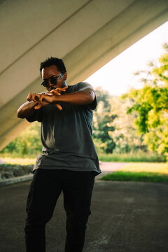 A Dancer Poses Beneath A Bridge In The City
