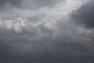 Blue sky in the gap between dark rain clouds