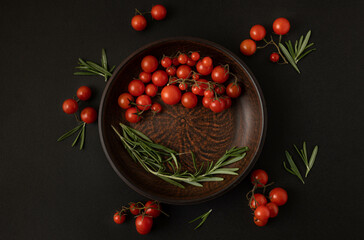 Сherry tomatoes in a bowl on a dark background.