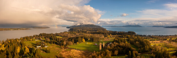 Fototapeta premium Panoramic Aerial View Of Lummi Island And A Rainbow In The Distance.