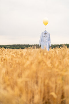 Blue clothes hanging at the hanger with yellow balloon