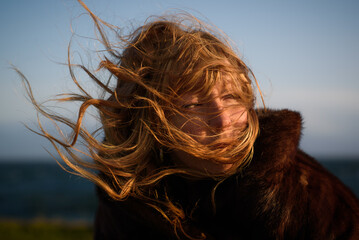 Woman with cold winds blowing