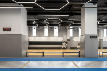 Competition of sportsmen in fencing inside sports club