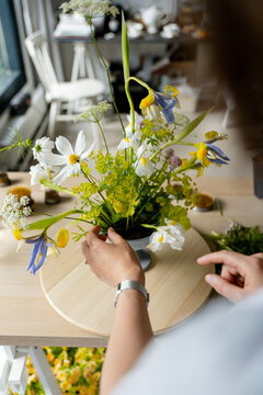 Female florist in a studio creating a beautiful bouquet 
