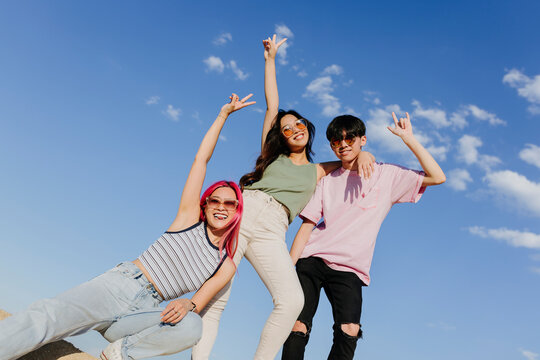 Happy women with raised arms