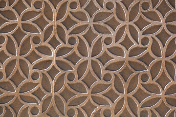 Texture background from a stucco wall covered with traditional patterns in Segovia, Spain