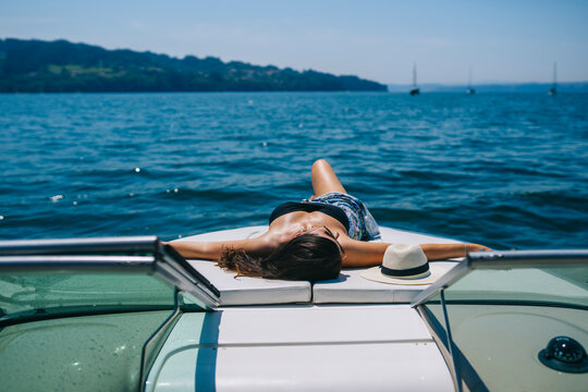 Woman resting on yacht on resort
