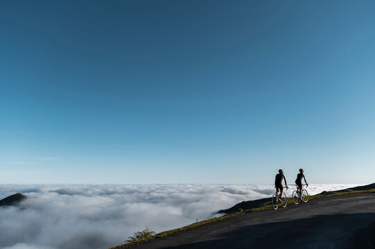 Cyclists riding on mountain trail - Powered by Adobe