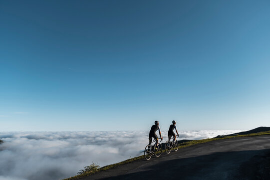 Cyclists riding on mountain trail - Powered by Adobe