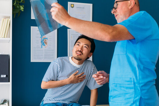 Doctor Showing X -Ray Image to Patient 
