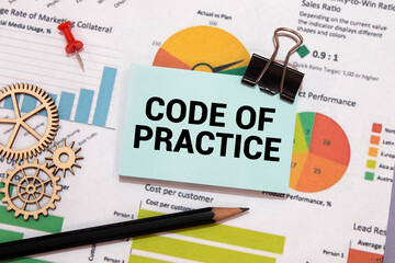 CODE OF PRACTICE text on the paper sheet with chart,color paper and calculator