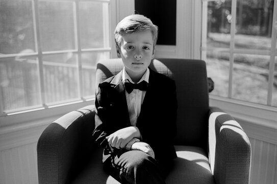 Adorable young boy in a tuxedo