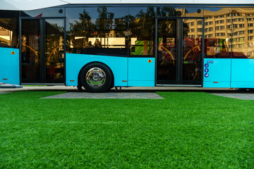 A new modern bus with an electric motor at the technology exhibition. Bus exterior close-up.