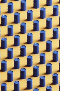 Group of blue oil drums isolated on yellow background