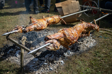 Whole lamb lambs roasted on a barbecue spit. Outdoor Barbecue grill a classic traditional open bbq pit. Steaks and meat cooked on a wood fire grill.