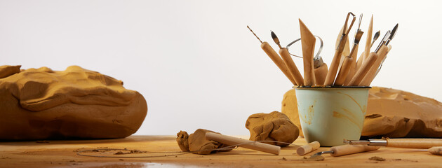 Various instruments for carving clay placed on table