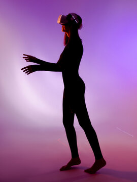 Full-length side view portrait of woman using virtual glasses 