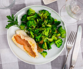 Plate with delicious fillet of gallineta with broccoli, decorated with a sprig of parsley