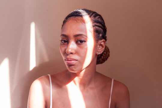 Portrait of Black woman with freckles and braids