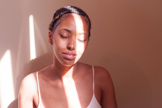 Portrait of Black woman with freckles and braids