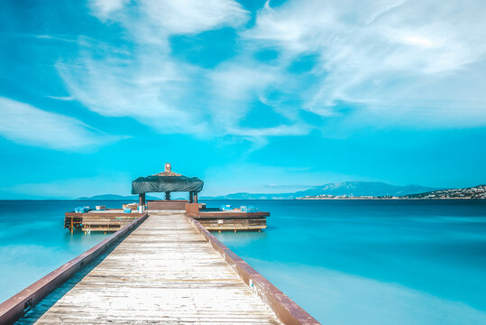 Touristic destination with beautiful blue sky and water, clear sea wodden pier on spring time