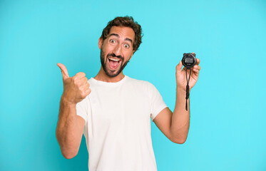 young crazy bearded and expressive man with a stopwatch timer. fast concept