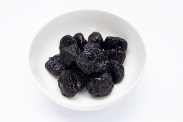 Dried prunes on white background
