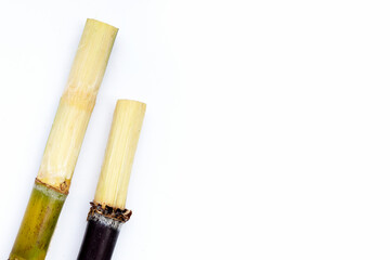 Sugar cane with brown sugar on white background
