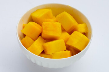 Yellow mango slices on white background.