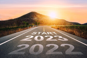 Start 2023 written on highway road in the middle of empty asphalt road of asphalt road at sunset.Concept of planning and challenge, business strategy, opportunity ,hope, new life change.for 2022-2023.